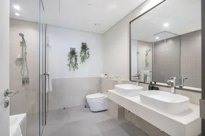 a bathroom with two sinks and a toilet and a shower at Vogue Al Wasl 1 Residences Near Zabeel Park and World Trade Centre, Two Bedroom Apartment with Balcony offering Dubai Frame and City View, Access to all Amenities, Walkable to Max Fashion Metro Station in Dubai