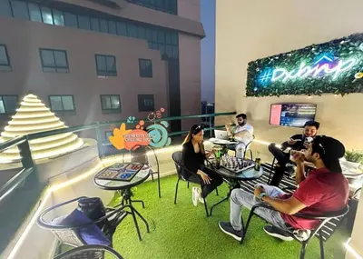 a group of people sitting in chairs in a building at Contemporary Room in Barsha Heights Tecom Near ICM Metro in Dubai