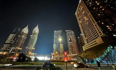 a group of tall buildings in a city at night at Contemporary Room in Barsha Heights Tecom Near ICM Metro in Dubai