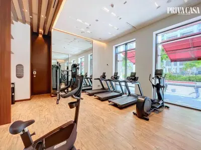 a gym with treadmills and ellipticals in a building at PRIVA CASA - Luxurious 2BR Vida Creek Beach - Beach access in Dubai