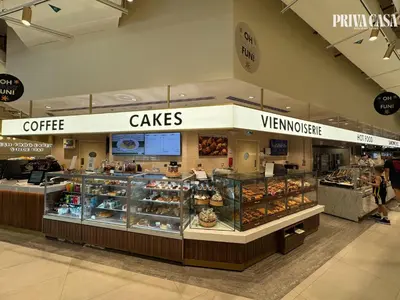 a bakery with a counter with pastries and cakes at PRIVA CASA - Luxurious 2BR Vida Creek Beach - Beach access in Dubai