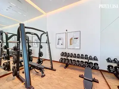 a gym with a row of tread machines at PRIVA CASA - Luxurious 2BR Vida Creek Beach - Beach access in Dubai