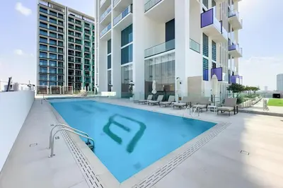 a swimming pool on the roof of a building at Cosy Studio in Binghatti House in Dubai