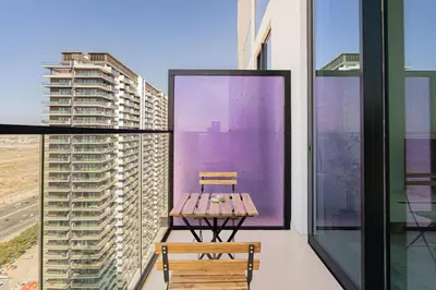 a bench on the balcony of a building at Escape24 Modern 1BR Balcony with City View in Dubai