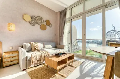 a living room with a couch and a table at Starfish Palm Views Studio in Dubai