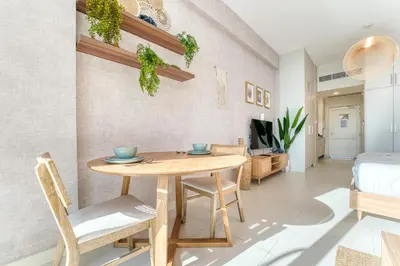 a dining room with a table and chairs at Starfish Palm Views Studio in Dubai