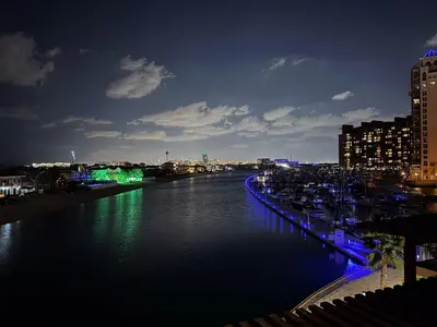 a view of a river at night with buildings at Octopus - Iconic Palm Studio With Views in Dubai