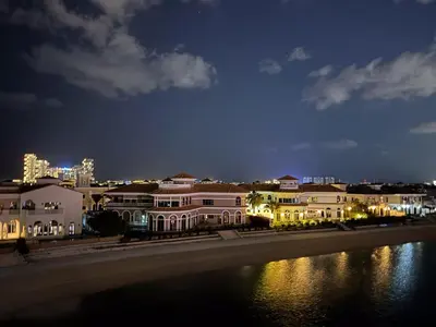a row of houses at night next to a river at Octopus - Iconic Palm Studio With Views in Dubai