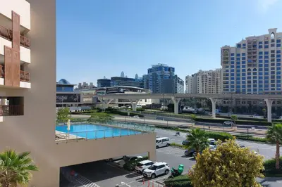 a pool in a parking lot in a city at Octopus - Iconic Palm Studio With Views in Dubai