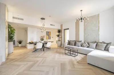 a living room with a couch and a table at Daniels 1BR at Sadaf JBR in Dubai