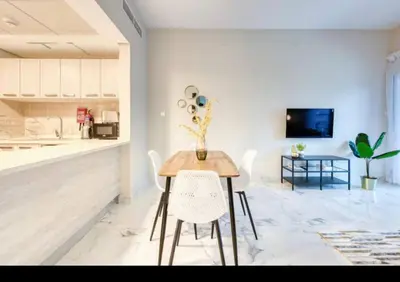 a kitchen and dining room with a table and chairs at 012 - Dubai South in Dubai