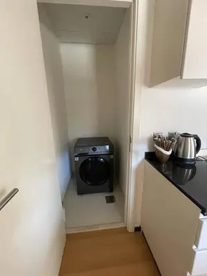 a small laundry room with a washer and dryer at 014 - Damac Hills in Dubai