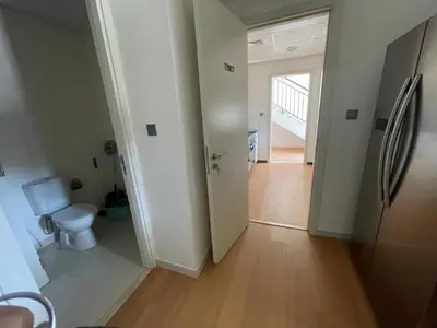 an empty room with a toilet and a hallway at 014 - Damac Hills in Dubai
