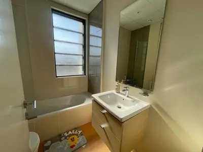 a bathroom with a sink and a tub and a mirror at 014 - Damac Hills in Dubai