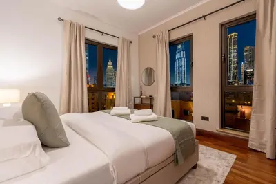 a bedroom with two beds and a large window at GuestReady - Downtown retreat with city views in Dubai