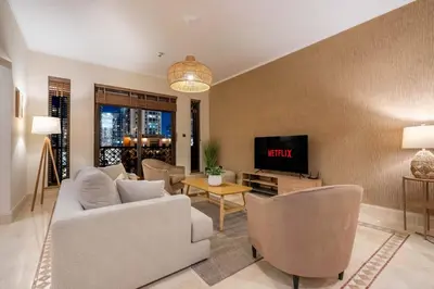 a living room with a couch and a tv at GuestReady - Downtown retreat with city views in Dubai