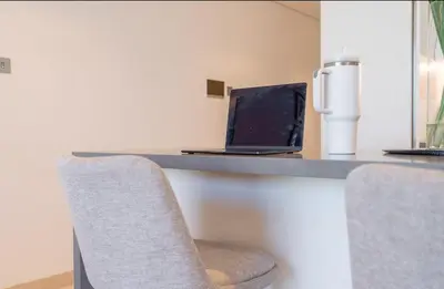 a desk with a laptop computer sitting on top of it at Luxury Apt with Full Burj Khalifa Skyline Views in Dubai