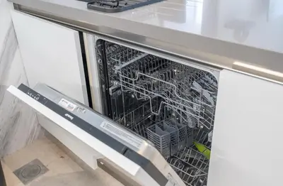 an open dishwasher with a dish rack in it at Luxury Apt with Full Burj Khalifa Skyline Views in Dubai