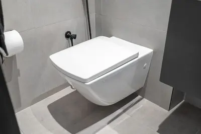 a bathroom with a white toilet in a stall at Water Front Apartment, Burj Khalifa Views in Dubai