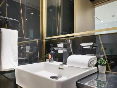 a bathroom with a white sink and a mirror at EasyGo- Stylish 1BDR with view and astonishing Facilities JVC in Dubai