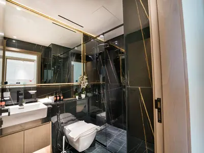 a bathroom with a toilet and a sink and a mirror at EasyGo- Stylish 1BDR with view and astonishing Facilities JVC in Dubai