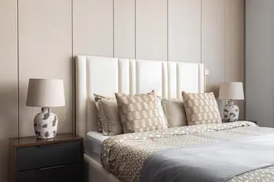 a bedroom with a bed with pillows and two lamps at SIMPLY COMFORT Apartments at Nobles Tower Luxury Burj View in Dubai