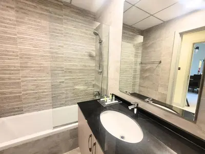 a bathroom with a sink and a mirror at Polo Residence C1 - Blue Ocean Holiday Homes in Dubai