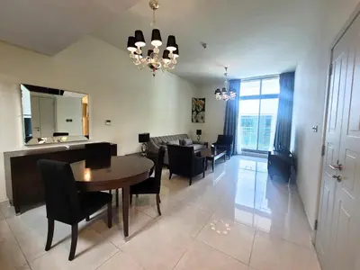 a dining room and living room with a table and chairs at Polo Residence C1 - Blue Ocean Holiday Homes in Dubai