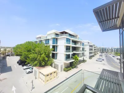 an apartment building in a city with a parking lot at Polo Residence C1 - Blue Ocean Holiday Homes in Dubai