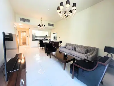 a living room with a couch and a table at Polo Residence C1 - Blue Ocean Holiday Homes in Dubai
