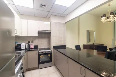a kitchen with a counter top and a stove at Polo Residence C1 - Blue Ocean Holiday Homes in Dubai