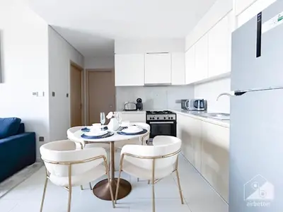a kitchen with a table and chairs in a room at Luxurious Burj Royale 1B Apt With Balcony & City Views in Dubai
