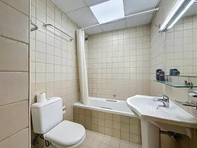 a bathroom with a toilet and a sink and a tub at Marina 1 Bedroom Gem in Dubai