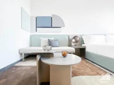 a room with a bed and a table and a couch at Stylish Studio Getaway in Dubai's MAG 920 in Dubai