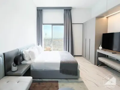 a bedroom with a bed and a large window at Stylish Studio Getaway in Dubai's MAG 920 in Dubai