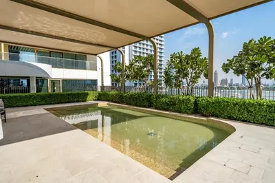 a swimming pool on the roof of a building at Homes Beyond I Stunning Oceanfront 2 BR Apartment in Dubai