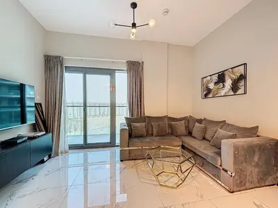 a living room with a couch and a television at Family friendly 2-bedroom in Dubai