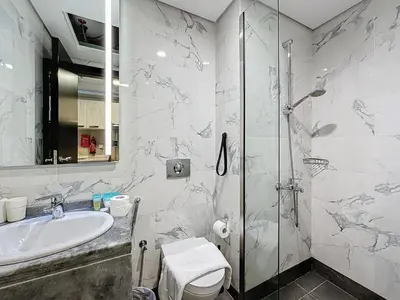 a bathroom with a shower and a sink at Family friendly 2-bedroom in Dubai