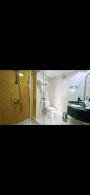 a bathroom with a shower and a toilet and a sink at Cozy Dubai Marina Suite in Dubai