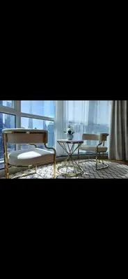a table and a bench in a room with a window at Cozy Dubai Marina Suite in Dubai