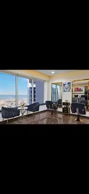 a living room with couches and chairs and windows at Cozy Dubai Marina Suite in Dubai
