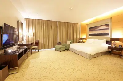 a hotel room with a bed and a flat screen tv at Partial Burjkhalifa View from Balcony in Dubai Mall-Studio King Bed in Dubai