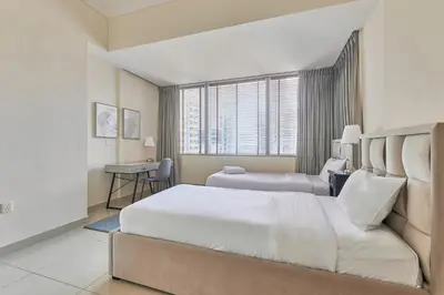 a hotel room with a large bed and a desk at Cozy 2bd in Dubai Marina in Dubai