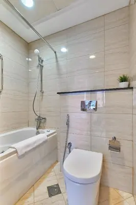 a bathroom with a toilet and a bath tub at Cozy 2bd in Dubai Marina in Dubai