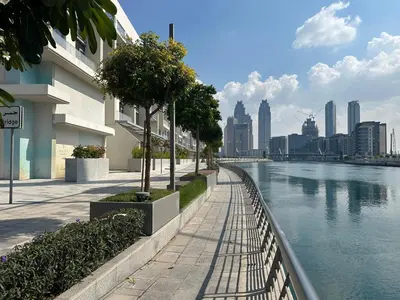 a river next to a city with buildings at Luxury Jumeirah canal front designer stay sleeps4 in Dubai