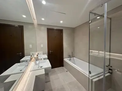 a bathroom with three sinks and a tub and a shower at Luxury Jumeirah canal front designer stay sleeps4 in Dubai