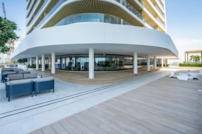 a building with couches and chairs in front of it at Homes Beyond I Modern 2BR Getaway with Beach Access in Dubai