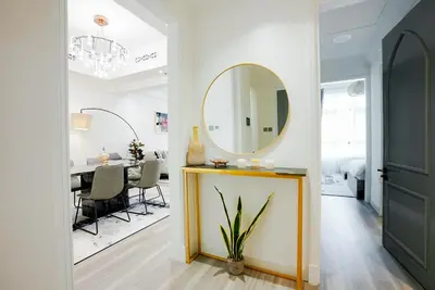 a dining room with a mirror and a table at Souk Al Bahar Dubai Fountain and Burj Khalifa view from the Balcony, 2 mins walk to Dubai Mall by Norbu Holiday Homes in Dubai