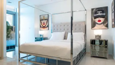 a bedroom with a four poster bed with a metal frame at KeyRock Living - Luxe Retreat at Paramount in Dubai