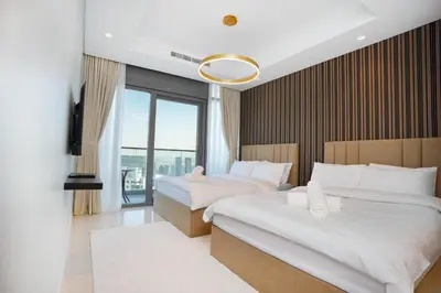 a hotel room with two beds and a balcony at 5 Star Stay, Infinity Pool with Burj Khalifa Views in Dubai